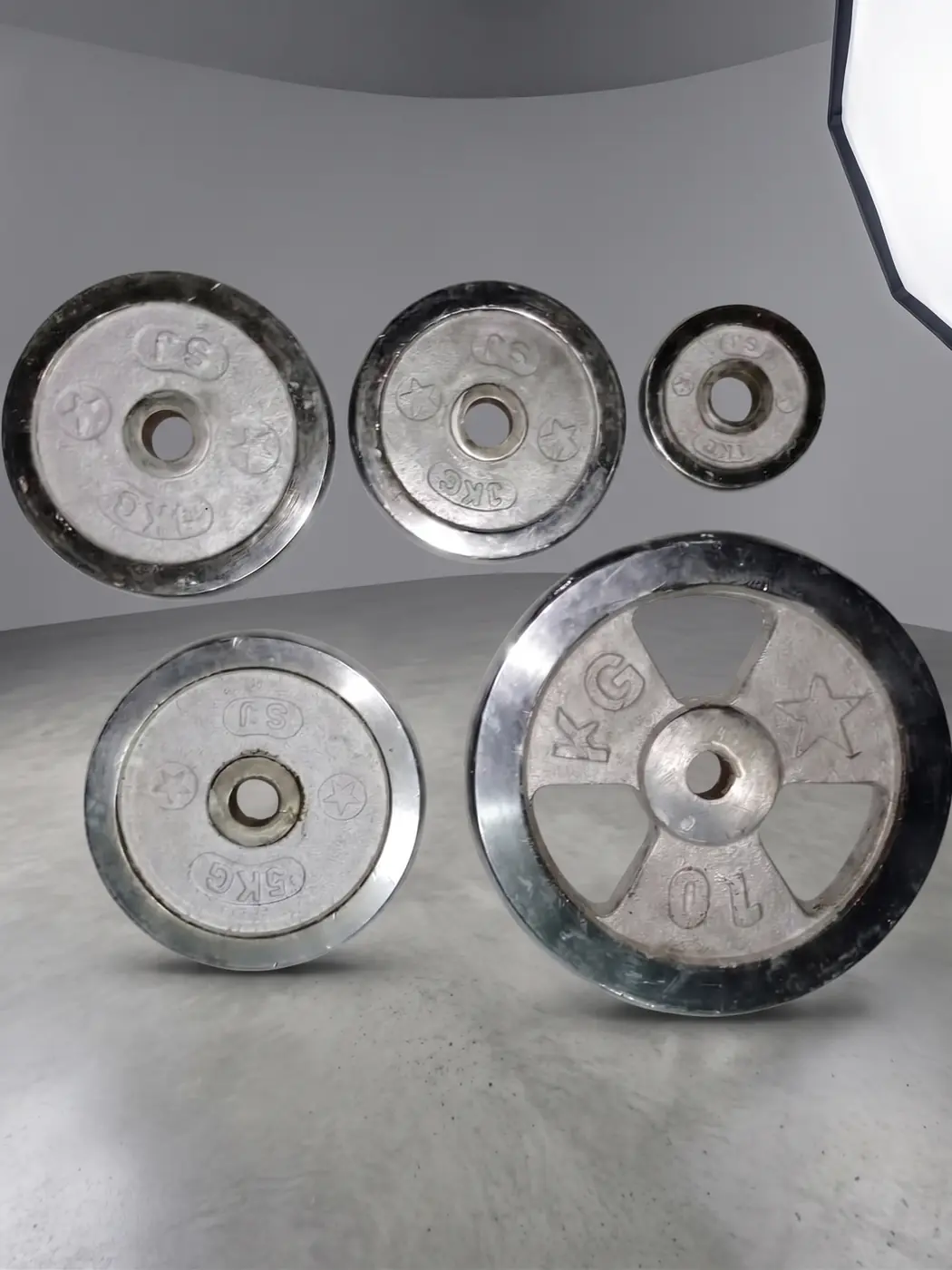 Mixed cast iron gym weight plates in several sizes