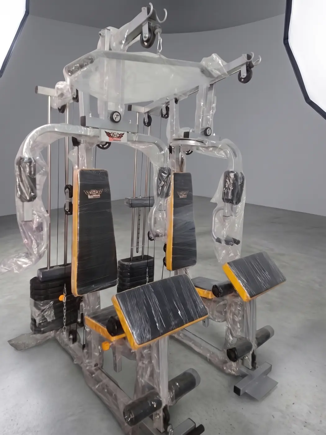 Dual station gym machine with two seats and weight stacks
