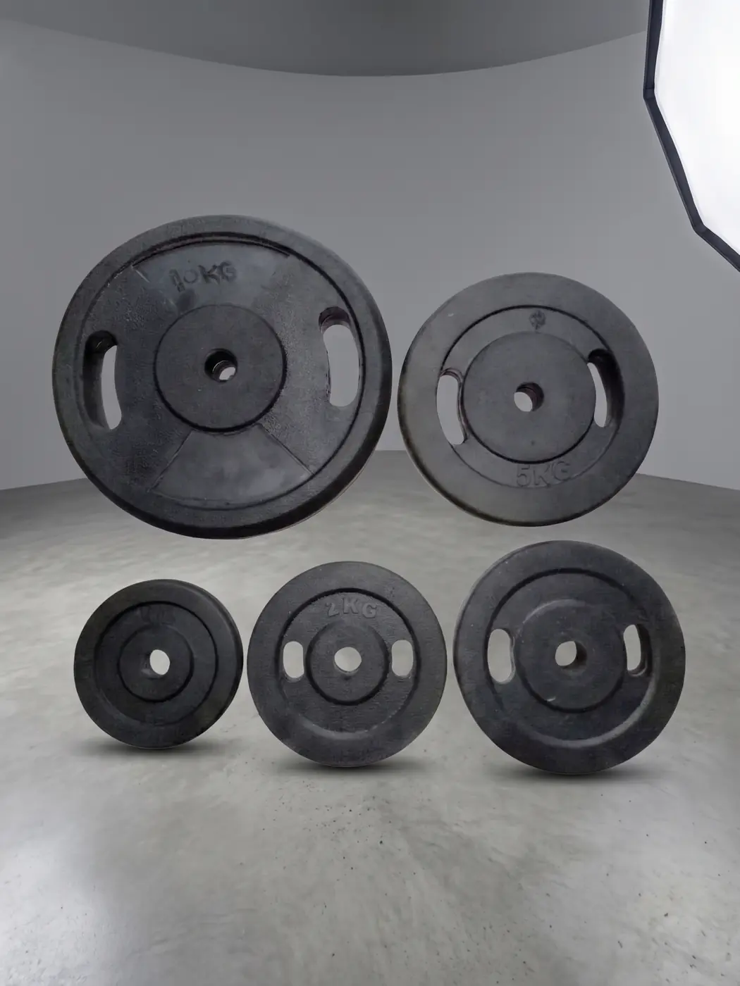 Black rubber coated gym weight plates in assorted sizes